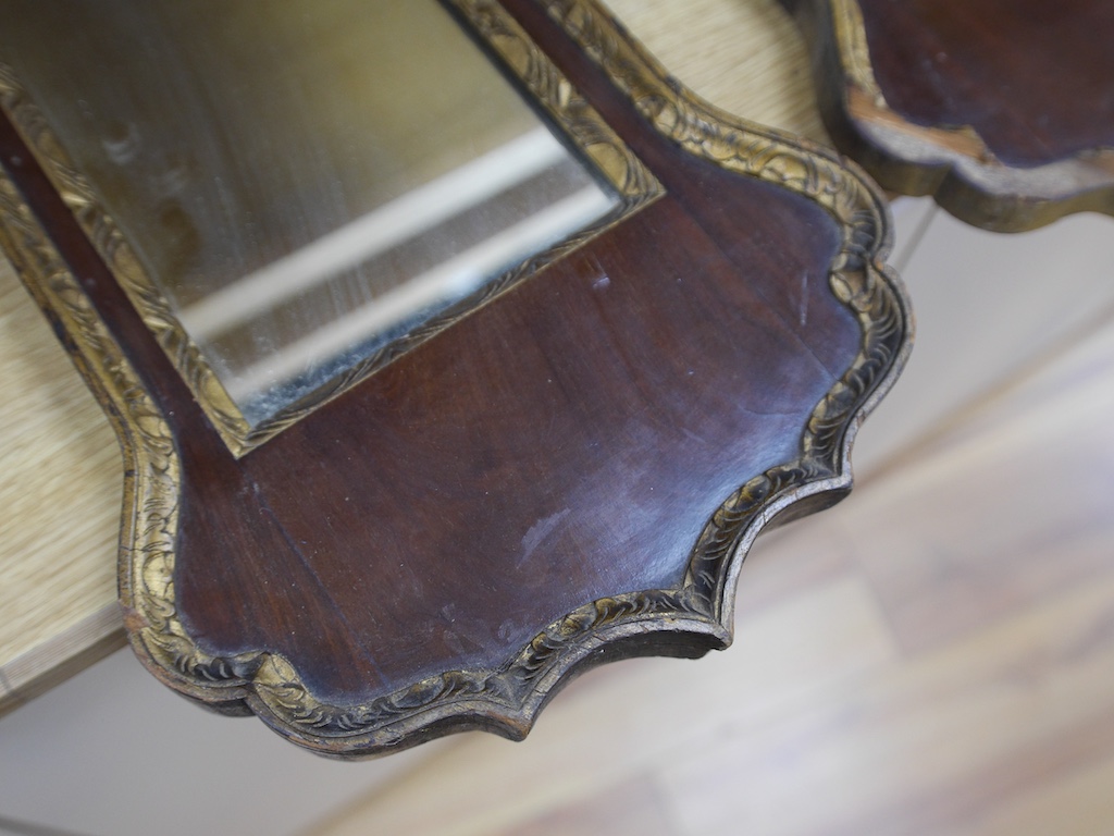 A pair of late 19th / early 20th century mahogany pier glass mirrors in George II style, 75 x 33cm. Condition - fair